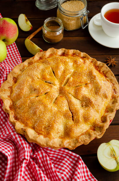 istock Classic American apple pie with cinnamon on a dark wooden background. Rustic style. Copy space. 1270084104