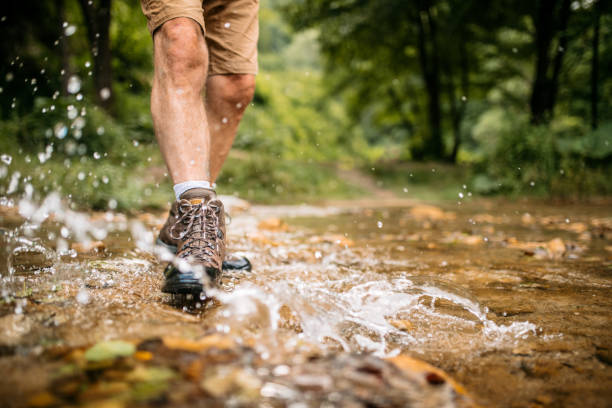 istock Hiking boots splashing in a forest creek 1270084955
