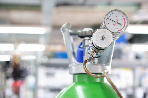 Gas cylinders with pressure gauge in a specialized laboratory