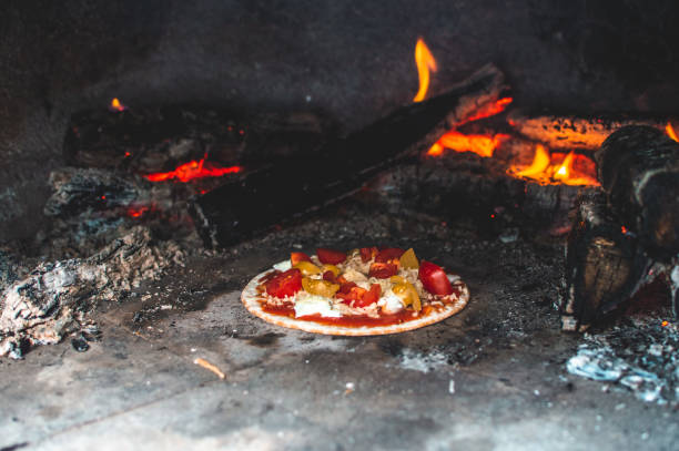 istock Homemade pizza in a pizza oven 1270086975
