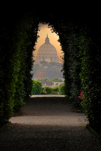 Rome, Italy - August 27, 2020: View of St. Peter's Basilica as seen from the Keyhole on the door of the Villa del Priorato di Malta (or Magistral Villa).