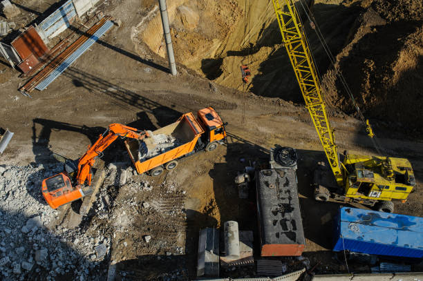 istock excavator moving earth and unloading into a dumper truck 1270091336