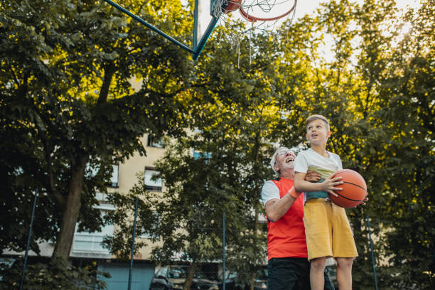 istock Boy and his grandfather playing basket 1270094985