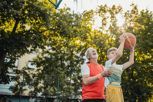istock Boy and his grandfather playing basket 1270095615