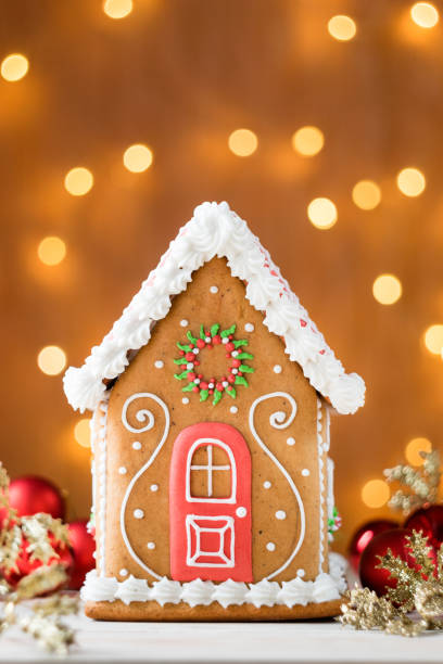 istock Winter Holiday Gingerbread house with lights in background, vertical orientation, selective focus. 1270095712