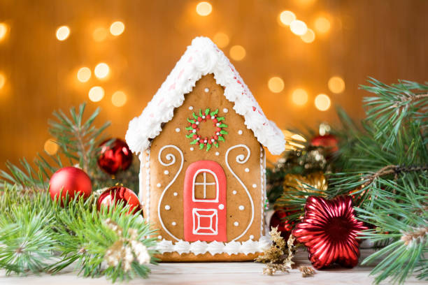 istock Beautiful gingerbread house with pine branches and christmas decorations, lights in background, horizontal orientation, selective focus 1270095743