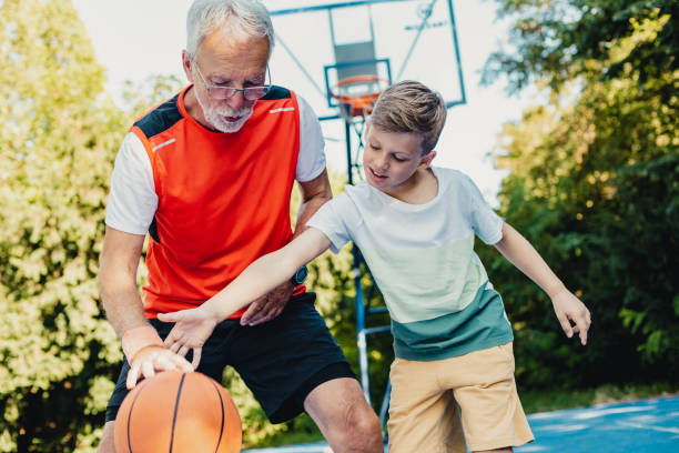 istock Boy and his grandfather playing basket 1270095791