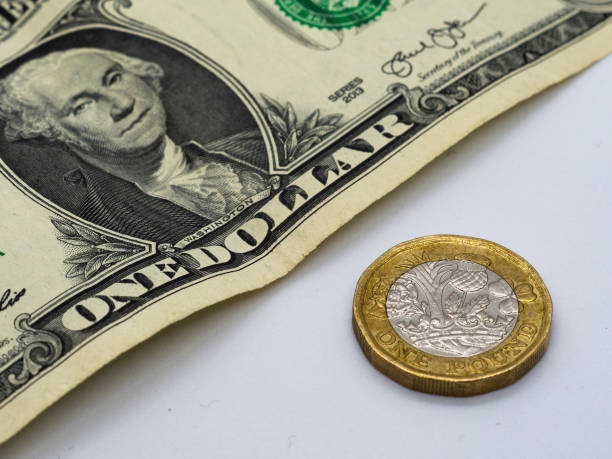 istock One pound coin next to a dollar bill 1270099701