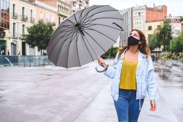 istock young red-haired woman with umbrella checking if still rains 1270101366