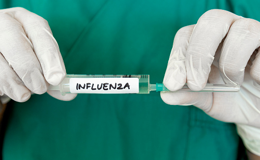 Doctor showing Influenza Vaccine.