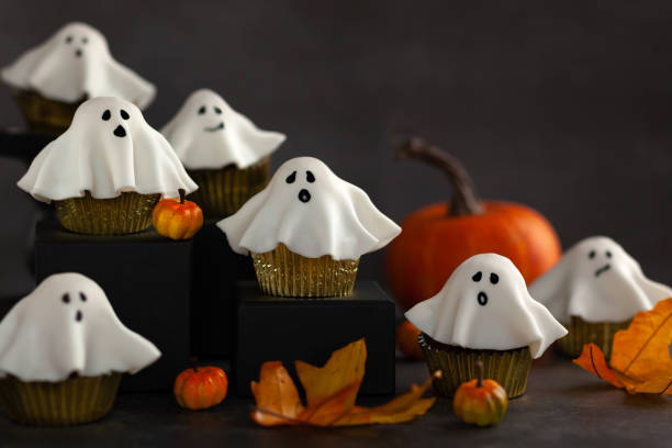 Halloween party food idea. Halloween fondant ghost cupcakes on black podiums.  Halloween party food idea. halloween cupcake stock pictures, royalty-free photos & images