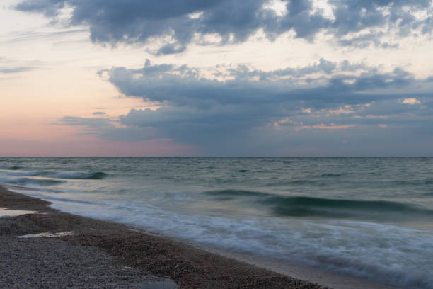 istock Dawn at  stormy sea. 1270104756