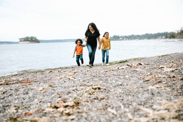 istock Family Playing Together on Pacific Northwest Beach 1270104768