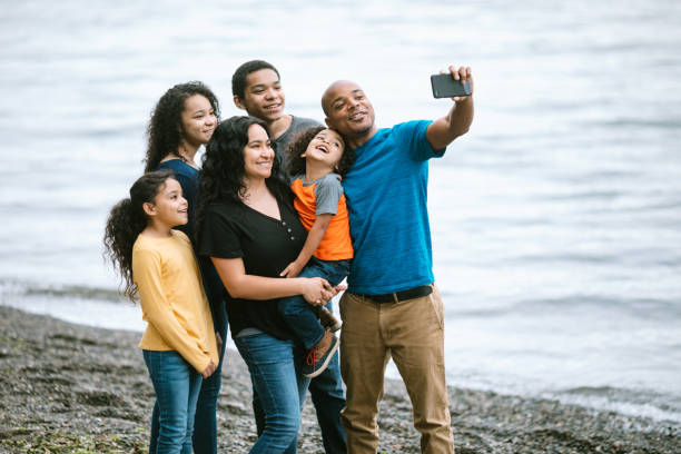 istock Family Taking Selfie Together on Pacific Northwest Beach 1270104847