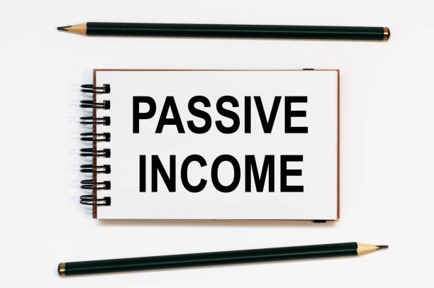 istock WHITE SPIRAL NOTEBOOK, TWO PENCILS WITH TEXT PASSIVE INCOME 1270104888