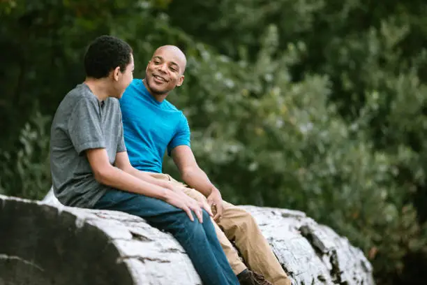 Photo of Father and Teenage Son Have Heart to Heart Talk