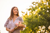 Pretty woman holding a bunch of flowers