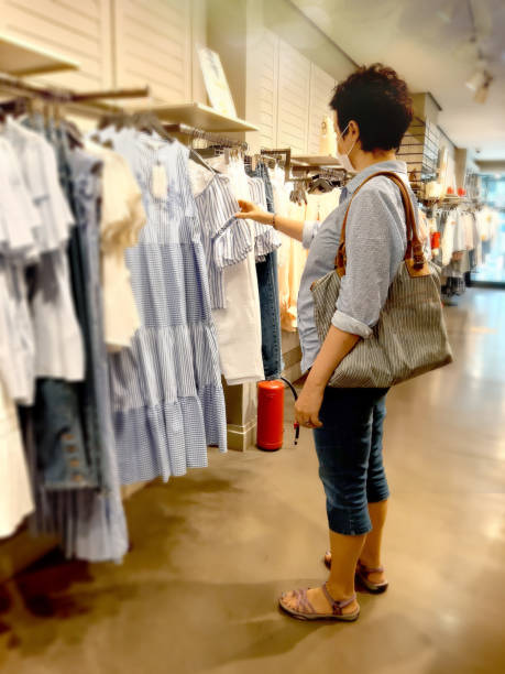 istock Woman Looking At Blouse While Out Shopping 1270107199