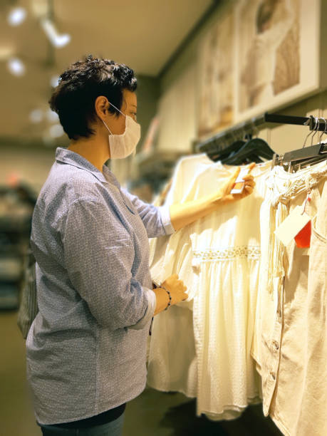 istock Woman Looking At Blouse While Out Shopping 1270107282