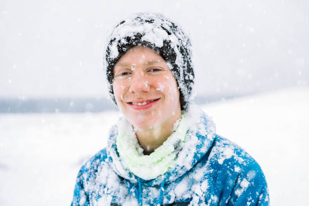 Playing and having fun in the snow wearing warm clothes in the cold. Enjoying the outdoors fresh air.