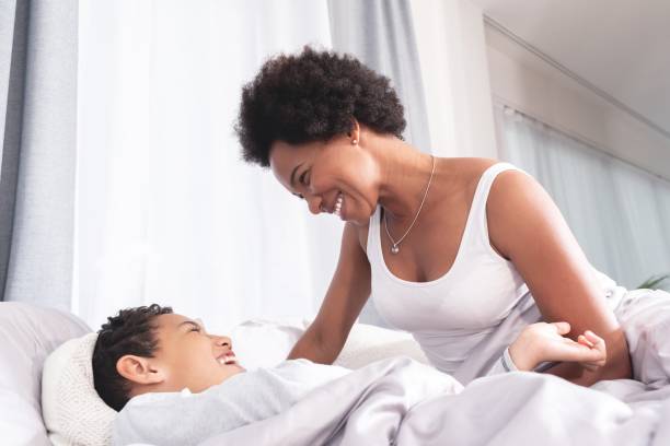 istock Joyful mother with little son on bed 1270107416