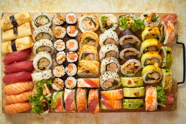 Above view of various sushi and rolls placed on wooden board. Japanese food fest stock photo