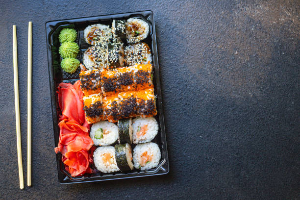 istock sushi rolls fish salmon, vegetables, ginger wasabi rice and nori on the table serving portion size top view place copy space for text 1270109591