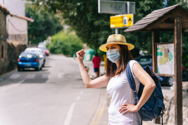 istock Freelance woman with mask doing hitchhiking 1270111991
