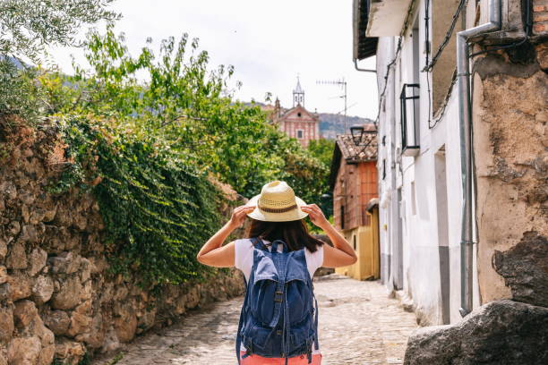 istock Independent woman sightseeing holding on to hat 1270112007