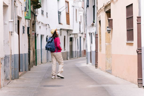 istock Woman sightseeing walking down a street 1270112027