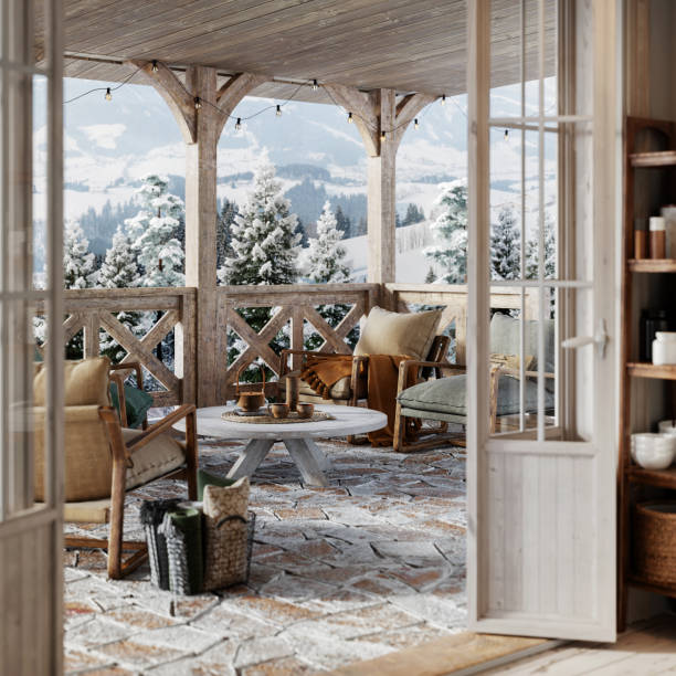 3d render of a balcony in snowy winter cottage Beautiful snowy winter cottage balcony with wooden center table, armchairs and coffee cups. cottage life stock pictures, royalty-free photos & images