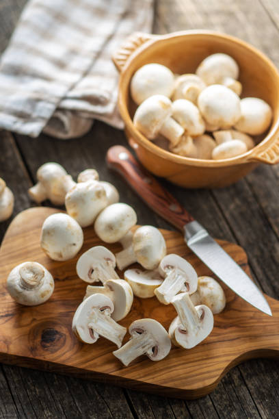 fresh white champignon mushrooms. - speisepilz stock-fotos und bilder