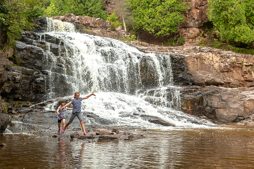Two young girls (sisters) exploring the Gooseberry Falls area in northern Minnesota, USA.