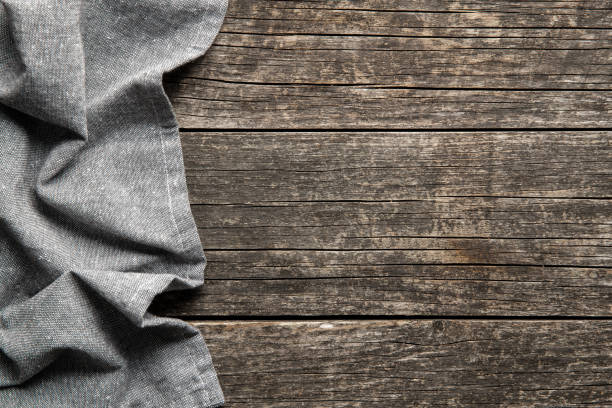 istock Folded tablecloth over antique wooden table. 1270114675