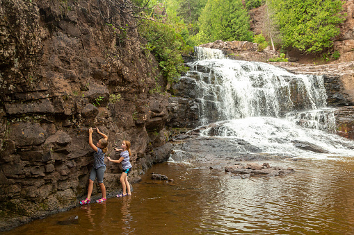 Two young girls (sisters) exploring the Gooseberry Falls area in northern Minnesota, USA.