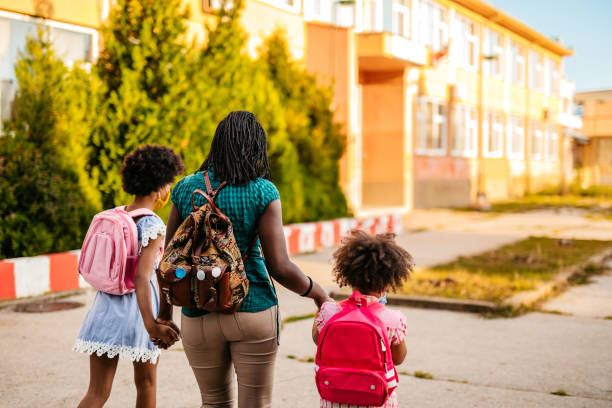 istock Mother taking her daughters to school 1270115937