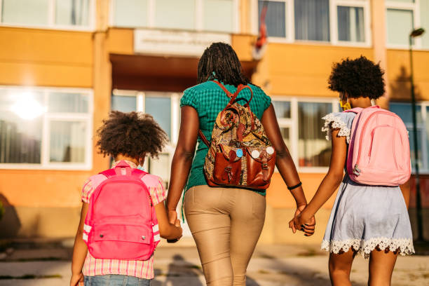 istock Mother taking her daughters to school 1270115964