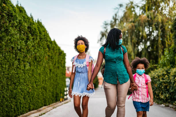istock Mother taking her daughters to school 1270116104