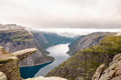 Dramatic view of small authentic town in the green summer mountains by the sea in Western Norway, Scandinavia