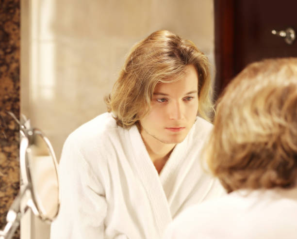 istock Applying the cream.young man looking in the mirror 1270118043