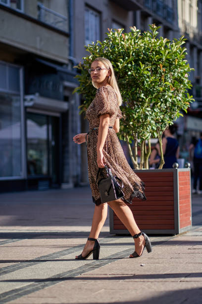 istock Young woman walking through the downtown 1270120125