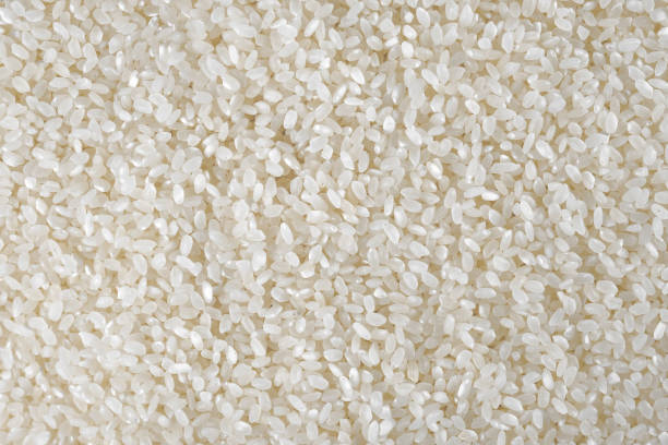istock White uncooked rice background. Indian cuisine ingredients. Close-up. 1270120932