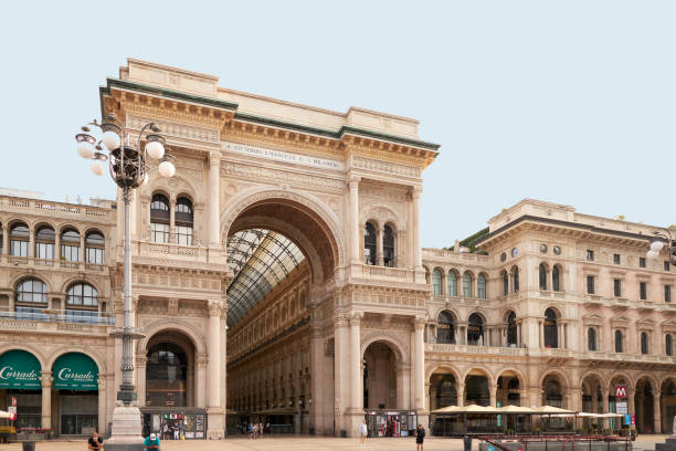 The Galleria Vittorio Emanuele II in Milan, Italy. 22.08.2020 The Galleria Vittorio Emanuele II in Milan, Italy. 22.08.2020 Bottom view of the front arch of the Vittorio Emanuele Gallery in Milan, taken during the day. A beautiful historical site. There is a lantern in the foreground. galleria vittorio emanuele ii stock pictures, royalty-free photos & images