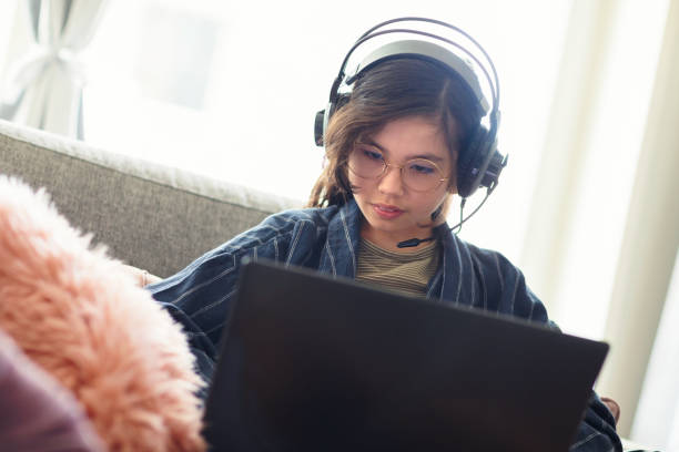 istock Girl playing video games on a laptop computer 1270126829