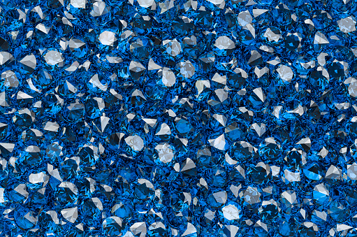 Background from blue diamonds or sapphires with brilliant cut. 3D rendering