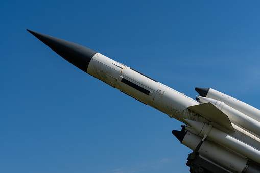 Detailed close up of an old Swedish missile or rocket (Rb68) on its launch ramp, against a blue sky in sunlight