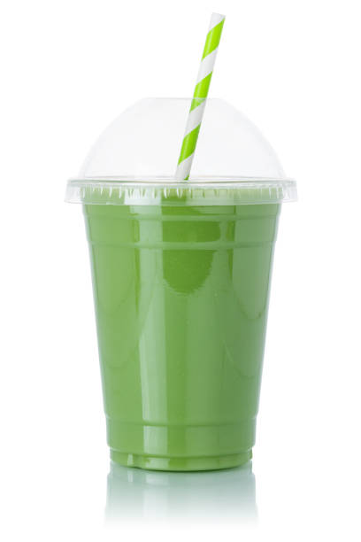 Green smoothie fruit juice straw drink in a cup isolated on a white background