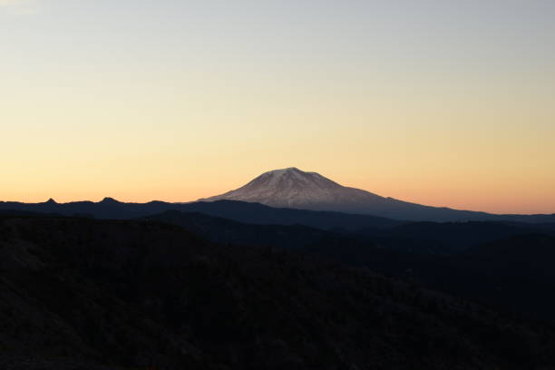 istock Illuminated Mountain Peak Beyond Silhouetted Landscape During Sunrise 1270133692