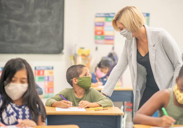 istock Elementary school children wearing face masks in class 1270134355