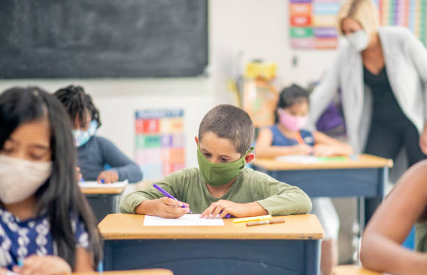 istock Elementary school children wearing face masks in class 1270134360